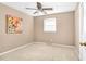 Neutral bedroom boasts a ceiling fan, a window letting in natural light, and soft carpet flooring at 4536 Massey Rd, Zebulon, NC 27597