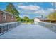 Spacious backyard wooden deck perfect for entertaining, offering views of the lawn and garage at 4536 Massey Rd, Zebulon, NC 27597