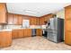 Well-equipped kitchen with stainless steel appliances and classic wood cabinetry at 4536 Massey Rd, Zebulon, NC 27597