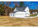 Three car garage featuring white siding and a concrete driveway at 50 Farmstead Ct, Wendell, NC 27591