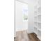 Bright hallway with hardwood floors, white walls, a window, and built-in shelving at 50 Farmstead Ct, Wendell, NC 27591