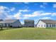 View of backyard featuring well-maintained lawns and attractive home exteriors within a residential area at 520 Oak Holly Ln, Zebulon, NC 27597