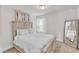Well-lit bedroom with a full bed, fluffy carpet, and neutral decor at 520 Oak Holly Ln, Zebulon, NC 27597
