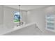 Bright hallway with modern chandelier and views to the exterior, showcasing the natural light and design elements at 520 Oak Holly Ln, Zebulon, NC 27597