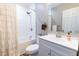 Clean bathroom with a shower-tub combo, white vanity, and updated fixtures at 522 E Club Blvd, Durham, NC 27704