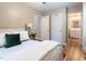 Bright bedroom featuring a plush bed, neutral walls, and access to a bathroom and closet space at 522 E Club Blvd, Durham, NC 27704