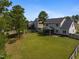 Expansive backyard featuring lush lawn and partial view of the home's exterior at 550 Spring Flowers Dr, Cameron, NC 28326