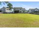 Large grassy backyard with fencing and a covered screened porch, ideal for outdoor living at 550 Spring Flowers Dr, Cameron, NC 28326