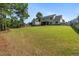 Extensive backyard featuring lush green grass, mature trees, and partial fencing at 550 Spring Flowers Dr, Cameron, NC 28326