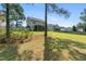 Expansive backyard with mature trees, partially fenced for privacy, and a covered patio at 550 Spring Flowers Dr, Cameron, NC 28326