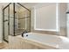 Bathroom featuring a soaking tub and glass-enclosed shower with tile surround at 550 Spring Flowers Dr, Cameron, NC 28326