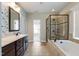 Bathroom featuring a vanity and a glass-enclosed shower with tile surround at 550 Spring Flowers Dr, Cameron, NC 28326