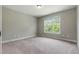 Comfortable bedroom featuring neutral paint, plush carpeting, and a bright window at 550 Spring Flowers Dr, Cameron, NC 28326