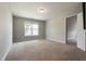 Neutral bedroom with a large window, carpet, and ensuite entrance at 550 Spring Flowers Dr, Cameron, NC 28326
