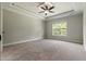 Neutral bedroom with decorative ceiling, fan, and large window at 550 Spring Flowers Dr, Cameron, NC 28326