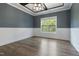 An elegant dining room featuring wainscoting, dark wood floors, and a stylish light fixture at 550 Spring Flowers Dr, Cameron, NC 28326