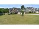 Well-kept home with lush green lawn, mature trees, and an attached two-car garage at 550 Spring Flowers Dr, Cameron, NC 28326