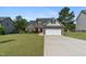 Charming two-story home with stone accents, lush landscaping, and a two-car garage at 550 Spring Flowers Dr, Cameron, NC 28326