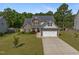 Charming two-story home with stone accents, lush landscaping, and a two-car garage at 550 Spring Flowers Dr, Cameron, NC 28326