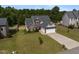 Inviting two-story home featuring a well-manicured lawn and attached two-car garage at 550 Spring Flowers Dr, Cameron, NC 28326