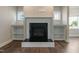 Bright living room fireplace with white shelves, and black mantle at 550 Spring Flowers Dr, Cameron, NC 28326