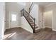 Elegant foyer featuring hardwood floors and a staircase with iron railings at 550 Spring Flowers Dr, Cameron, NC 28326