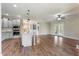 Open concept kitchen featuring an island, stainless appliances, and a view into the cozy living room at 550 Spring Flowers Dr, Cameron, NC 28326