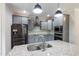 Modern kitchen with stainless steel appliances, gray cabinets, granite countertops, and a large kitchen island at 550 Spring Flowers Dr, Cameron, NC 28326