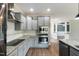 Modern kitchen with stainless steel appliances, gray cabinets, granite countertops, and subway tile backsplash at 550 Spring Flowers Dr, Cameron, NC 28326