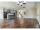 Open concept living space with kitchen, staircase, hardwood floors, and large windows with plenty of natural light at 550 Spring Flowers Dr, Cameron, NC 28326