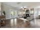 Bright living room boasts a fireplace, ceiling fan, and French doors to the backyard at 550 Spring Flowers Dr, Cameron, NC 28326