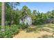 Outdoor storage shed nestled among mature trees, adding utility to the property at 550 Spring Flowers Dr, Cameron, NC 28326