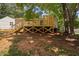 View of elevated deck with wooden supports from the backyard at 5911 Westcreek Pl, Raleigh, NC 27606