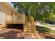 New wooden deck and steps lead to a grassy yard shaded by a large tree at 5911 Westcreek Pl, Raleigh, NC 27606
