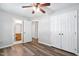 Bedroom featuring wood floors, ceiling fan and ensuite bathroom at 5911 Westcreek Pl, Raleigh, NC 27606