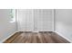 Bedroom with wood floors, window and double door closets at 5911 Westcreek Pl, Raleigh, NC 27606