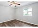 Bedroom featuring a wood floor, ceiling fan, and a window at 5911 Westcreek Pl, Raleigh, NC 27606