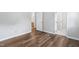 Bedroom with wood floors and entryways to ensuite bathroom and closet at 5911 Westcreek Pl, Raleigh, NC 27606