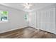 Bright bedroom featuring two windows, wood floors, and a large closet at 5911 Westcreek Pl, Raleigh, NC 27606