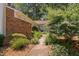 Charming home featuring a brick facade and meticulously landscaped walkway leading to the front door at 5911 Westcreek Pl, Raleigh, NC 27606