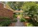 Charming home with a lush landscaped front yard and walkway, surrounded by mature trees at 5911 Westcreek Pl, Raleigh, NC 27606