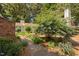 Charming home with a lush landscaped front yard and walkway, surrounded by mature trees at 5911 Westcreek Pl, Raleigh, NC 27606