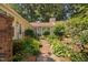 Charming home with a lush landscaped front yard and walkway, surrounded by mature trees at 5911 Westcreek Pl, Raleigh, NC 27606
