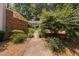 Charming home with a lush landscaped front yard and walkway, surrounded by mature trees at 5911 Westcreek Pl, Raleigh, NC 27606