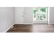 Bright living room featuring modern wood flooring, a large window, and a well-lit atmosphere at 5911 Westcreek Pl, Raleigh, NC 27606