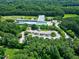 Aerial view of the building's parking lot and the lush surrounding greenery with many trees and plants at 608 Misty Isle Pl, Raleigh, NC 27615