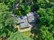 Scenic aerial view of a home surrounded by mature trees and a verdant landscape at 608 Misty Isle Pl, Raleigh, NC 27615