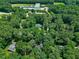 Distant aerial view showcasing the home's location amidst a canopy of trees and nearby building at 608 Misty Isle Pl, Raleigh, NC 27615