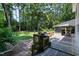 Wooden back deck offers a serene outdoor space with a grill and access to the spacious, tree-filled backyard at 608 Misty Isle Pl, Raleigh, NC 27615