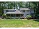 Back of house featuring a screened in porch and lush, green backyard at 608 Misty Isle Pl, Raleigh, NC 27615